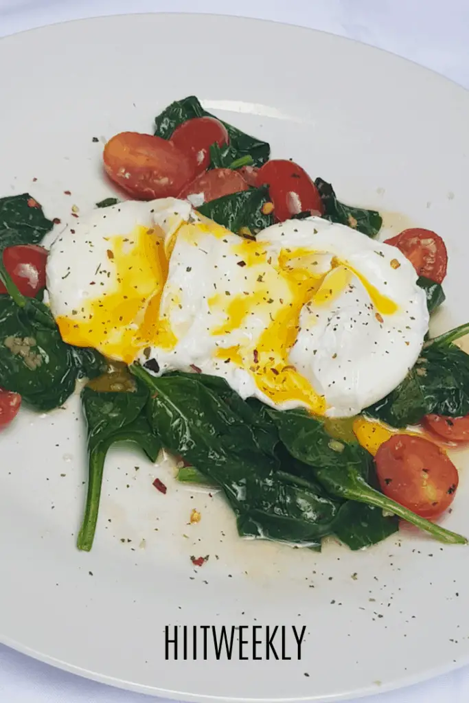 This poached eggs with garlic sauteed baby spinach and cherry tomatoes recipe is a super healthy breakfast idea. Enjoy part of a balanced diet of as a low carbohydrate breakfast option when trying to lose weight. 
